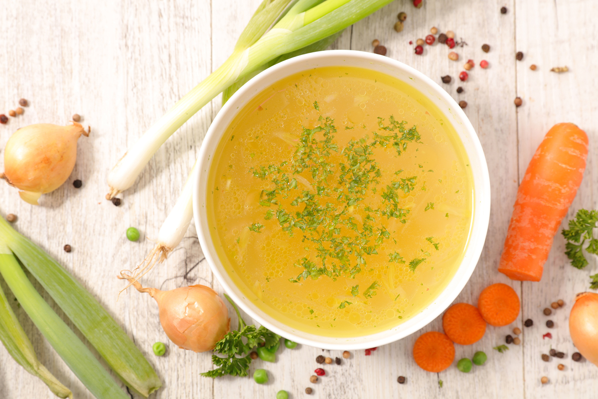 Vegetable stock surrounded by veggies