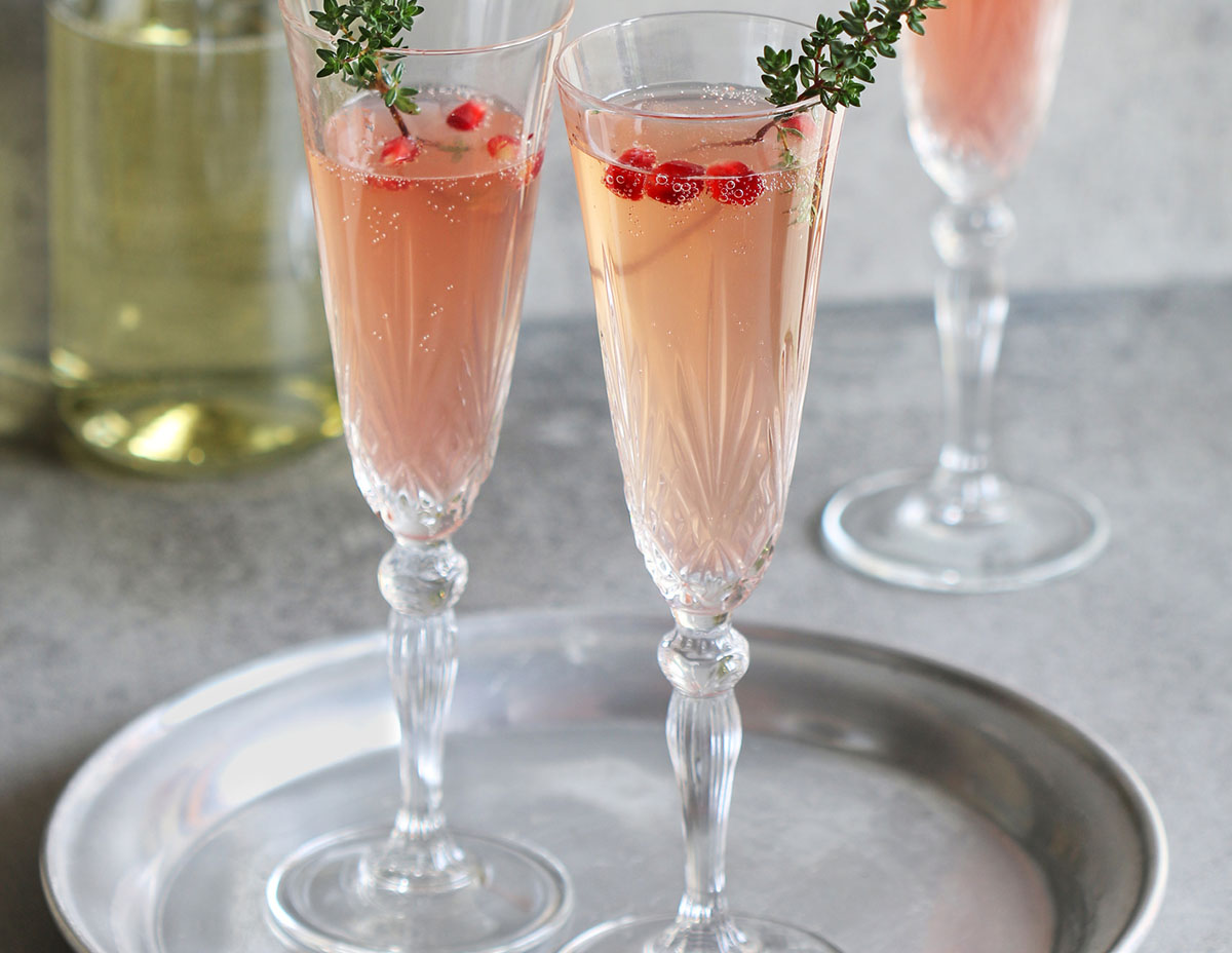 Pomegranate champagne in glasses on a tray