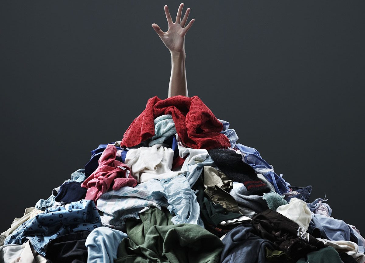 Hand coming out of pile of clothing