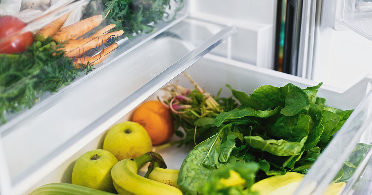 fresh veggies in open refrigerator drawer